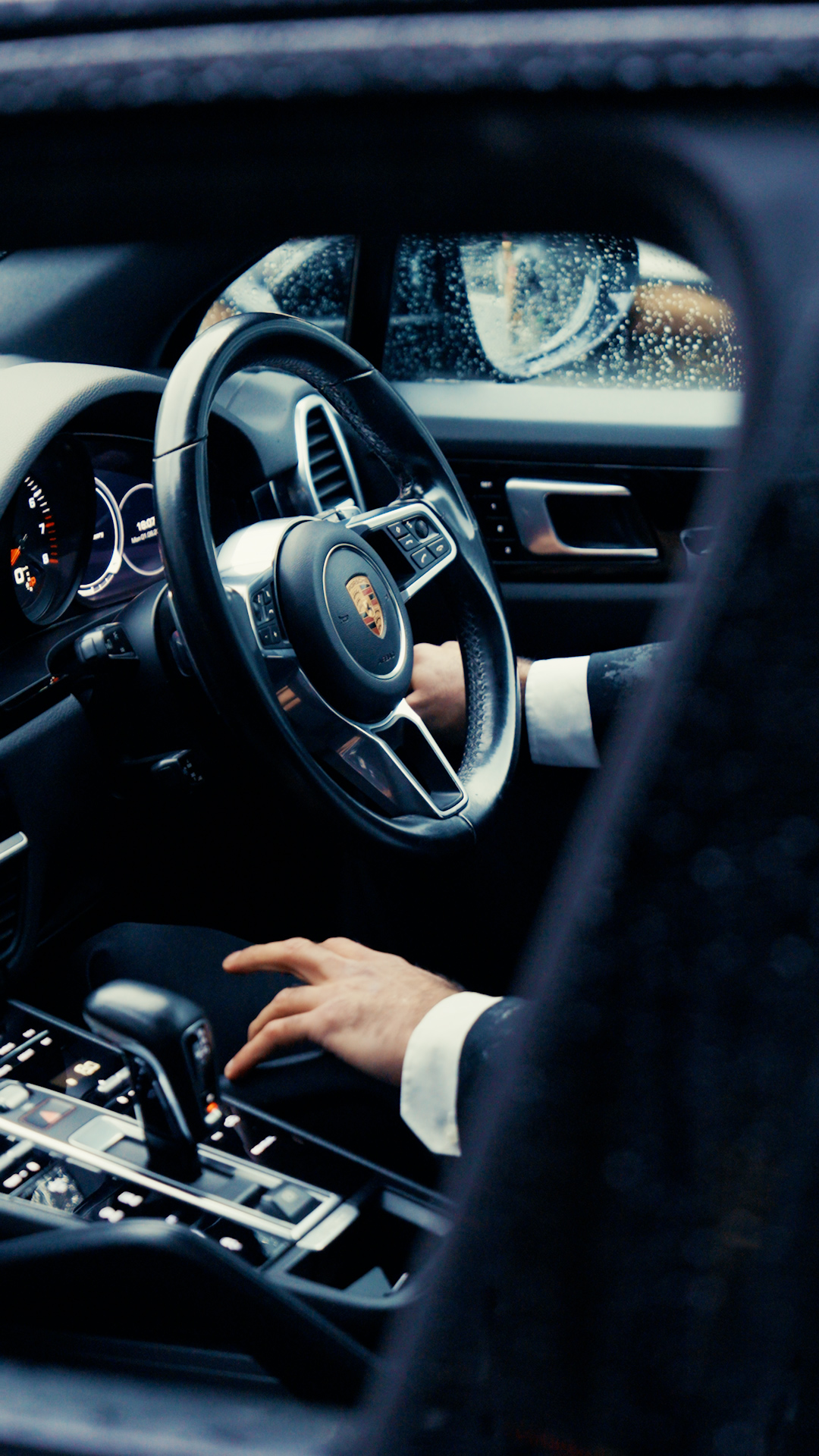 A private chauffeur preparing the Porsche for a Saint Serene guest